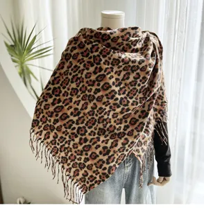 Close-up detail of soft leopard print fringe shawl showcasing fine texture and classic pattern.