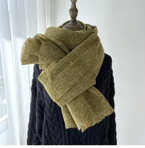 Detailed view of the olive green plaid fringe scarf, cozy autumn and winter accessory.