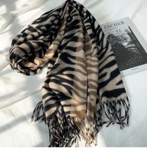 Detailed view of women's fall winter zebra print tassel cashmere feel scarf wrap accessory.