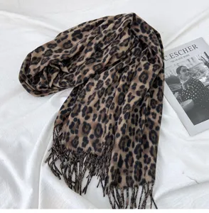 Leopard print scarf detail, soft imitation cashmere fabric, stylish tassel hem, cozy winter neckerchief accessory.