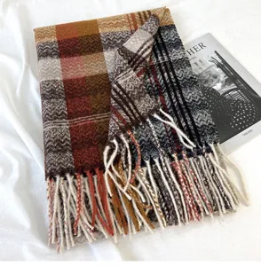 Detailed view of women autumn winter plaid knitted scarf with cozy tassels texture display.