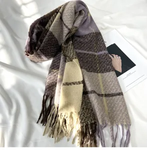 Detailed close-up of a soft cashmere-feel plaid fringe scarf in elegant purple and beige tones.