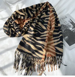 Detailed view of women's autumn winter imitation cashmere scarf featuring bold animal print.