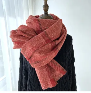Detailed close-up view of the red herringbone plaid scarf showing soft fabric texture.