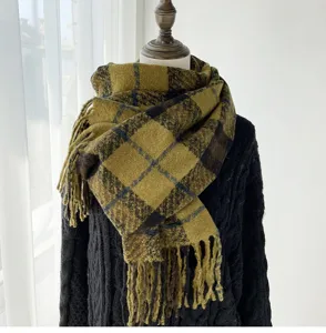 Close-up view of the warm plaid winter scarf detail, featuring cozy fringe and soft texture.