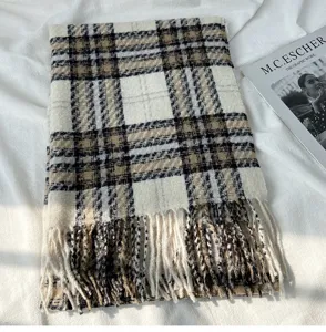 Detailed view of women's autumn winter cozy plaid cashmere feel scarf with chic fringe design.
