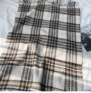 Detail shot of classic plaid imitation cashmere scarf with fringe, soft winter warm wrap.