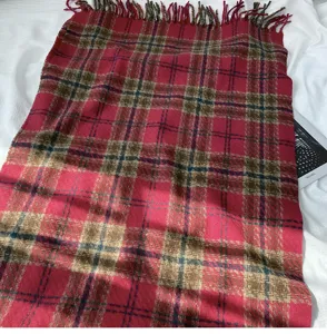 Detailed view of women autumn winter classic red plaid imitation cashmere scarf with tassels.