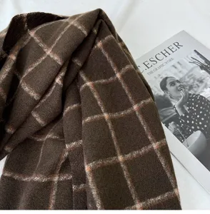 Close up view of cozy dark brown plaid imitation cashmere scarf winter warm fashion accessory.