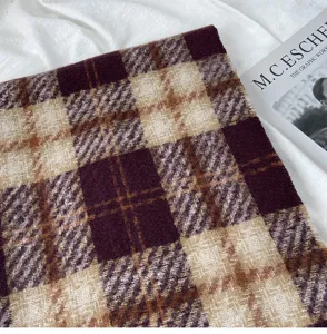 Detailed close-up of a stylish winter plaid imitation cashmere scarf with soft texture.