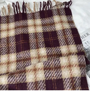 Detailed close-up of a cozy plaid imitation cashmere winter scarf with chic fringe.