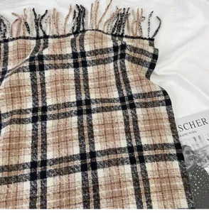 Detailed view of classic plaid scarf with fringe, soft textured wool-feel fabric, warm cozy style