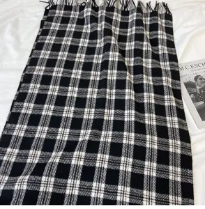 Classic black and white plaid winter scarf with cozy cashmere feel and stylish fringe details.