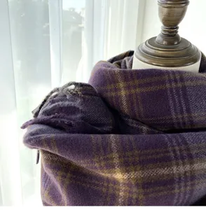 Close-up detail of a women retro Maillard purple plaid warm winter scarf cozy texture.