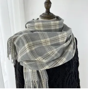 Detailed view of the grey winter plaid scarf with soft tassels, warm cashmere feel neckerchief.