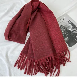 Detailed view of the dark red winter cashmere-feel scarf featuring elegant fringes and soft fabric.