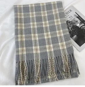Detail shot of winter warm plaid scarf with tassel design, soft cashmere-feel fabric.