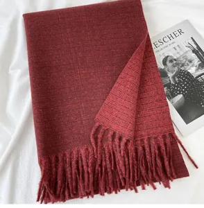 Red winter fringed scarf detail shot, cozy cashmere-feel fabric texture, elegant daily accessory.