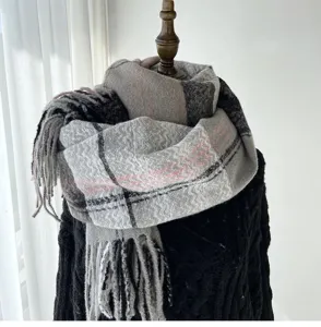Cozy gray plaid winter scarf with elegant tassels, thick warm cashmere-feel knit shawl detail view.