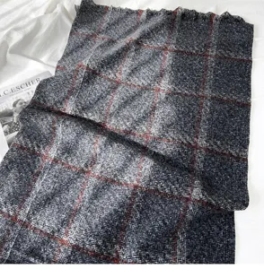 Soft plaid cashmere-feel winter scarf with red grid lines and chic fringe details.