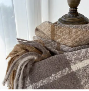 Cozy brown plaid fringed scarf detail, soft imitation cashmere material for winter warmth.