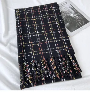 Black plaid cashmere-feel scarf with colorful flecks and fringe, detailed close-up shot.