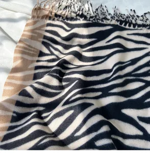 Detailed view of the winter zebra print imitation cashmere scarf with chic fringe and color block.