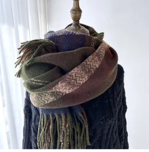 Detailed close-up view of the stylish colorful plaid patterned winter tassel scarf on mannequin.