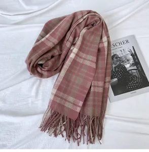 Detailed view of cozy pink and beige plaid imitation cashmere scarf, warm winter shawl.