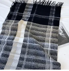 Detailed view of women's autumn winter imitation cashmere plaid tassel scarf in black and grey.