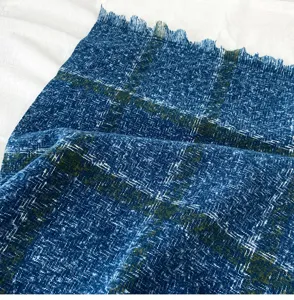 Close-up detail of blue plaid cashmere-feel scarf showing delicate fringe and textured weave