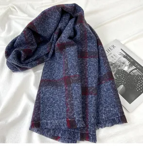 Detailed view of cozy blue plaid winter scarf with fringed edges for warm daily wear.