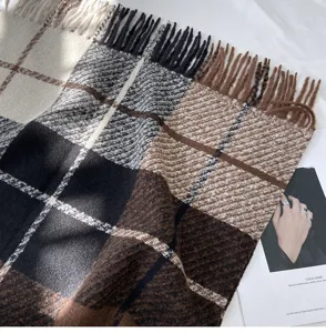 Classic plaid winter tassel scarf detail, cozy cashmere-like texture, warm stylish accessory.