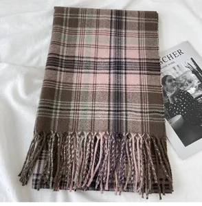 Close-up detail of a retro plaid winter scarf with cozy fringe tassels and elegant color blocking.