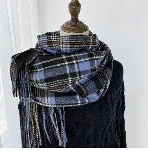 Detailed view of winter blue black plaid scarf, thick warm cashmere-like tartan wrap.