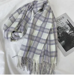 Close-up view of warm cashmere-feel plaid scarf featuring elegant tassels in purple.