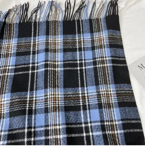 Cozy winter plaid scarf for women, featuring classic blue and black pattern with fringe.