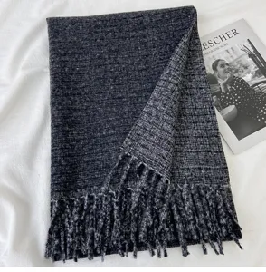 Dark grey cashmere-feel knit scarf detail, showing soft texture and elegant tassel hem.