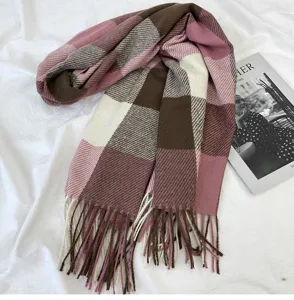 Detailed view of the stylish women's winter plaid tassel scarf in cozy brown and pink.