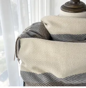 Cozy winter cashmere-feel scarf with chic herringbone pattern and fringe detail for women.