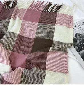 Plaid scarf detail showing soft fabric texture, cozy warm tassels, and elegant winter design.