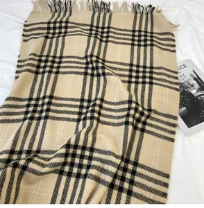 Detailed close-up of classic plaid cashmere feel fringe scarf winter warm shawl prop