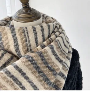 Detailed view of women's thickened winter striped scarf showing soft cashmere texture.