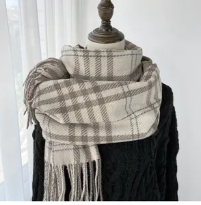 Detailed close-up view of the classic beige plaid scarf draped elegantly on mannequin.