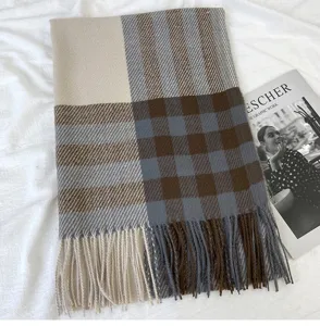 Detailed view of women's autumn winter cozy plaid scarf with stylish fringe tassel design.