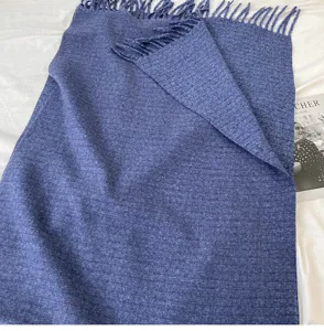 Blue solid cashmere-feel winter scarf with elegant fringe for women warmth and style.