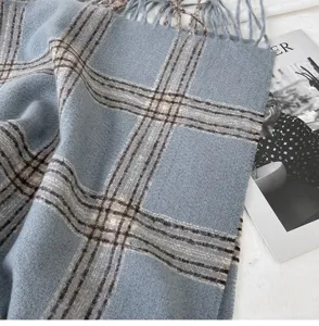 Cozy blue plaid winter scarf with classic tassels, soft and warm fashion accessory for women.