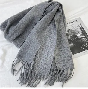 Cozy grey winter tassel scarf, soft cashmere-feel fabric, elegant warm accessory detail.