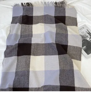 Cozy plaid scarf with classic checks and soft tassels for winter warmth and daily style.