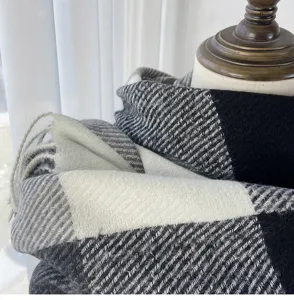 Black white grey plaid winter scarf close up texture warm cozy soft tassel fringe detail
